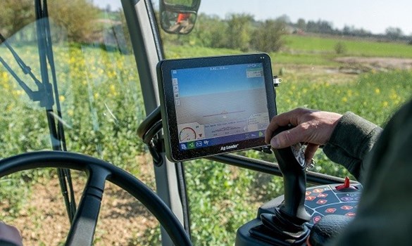 Richard Ling driving a sprayer through oilseed rape.